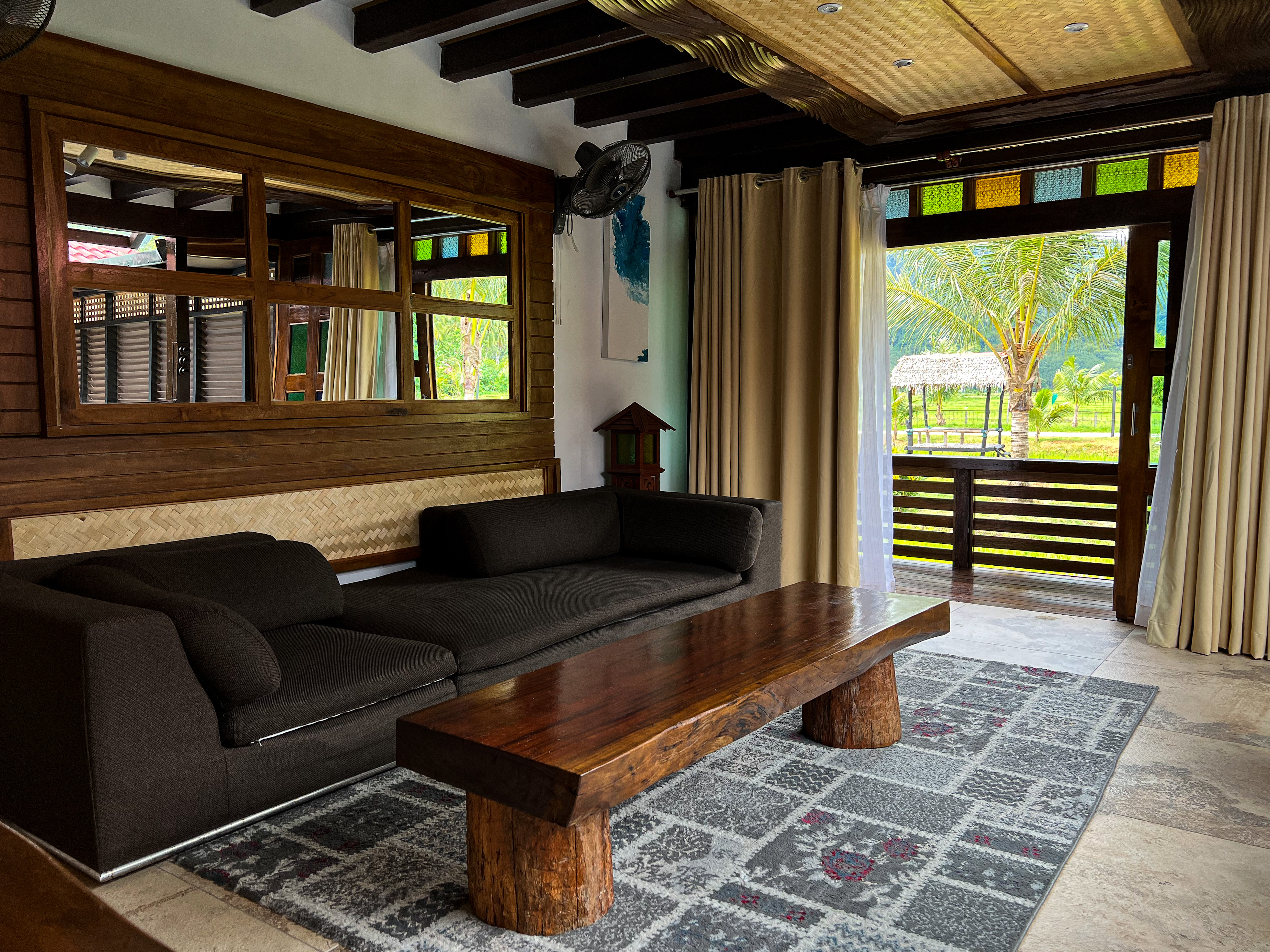 Villa Sawah living room with timber, woven bamboo and garden view